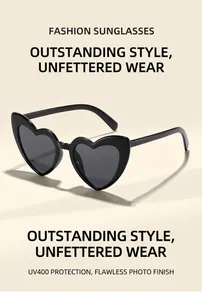 Detailed view of heart-shaped sunglasses with black resin frame and dark lenses
