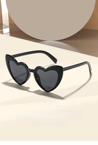 Detailed view of heart-shaped sunglasses with black resin frame and dark lenses