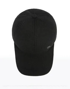 Top-down view of a grey winter baseball cap with fine knitted texture and metal shield logo