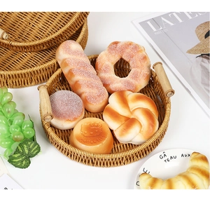 Detail of round woven fruit tray with wooden handles and handmade rattan texture
