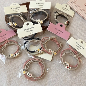Elastic fabric hair ties with engraved beads in pink and khaki, set in 2024 style
