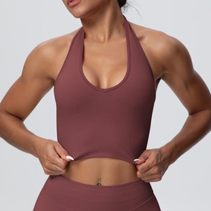 Detail of ribbed dark burgundy halter neck sports bra and high-waist yoga leggings