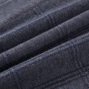 Detailed macro view of dark grey knit fabric texture on this casual men vest cardigan