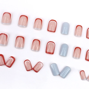 French tip red and white press-on nails with blue accents on a clean white background