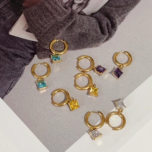 Detail view of square zircon drop earrings in gold plating and four vibrant colors