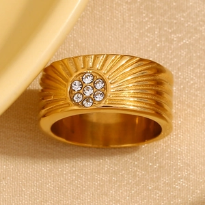 Detailed close-up of 18K gold plated ring with sunburst texture and zircon flower design