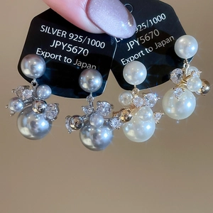 Vue macro de boucles d'oreilles en argent S925 plaqué or 14k avec perles et cristaux