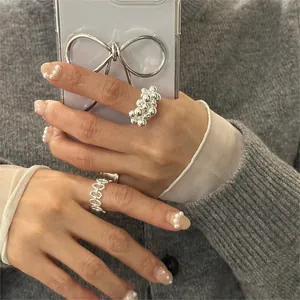 Close-up of minimalist S925 sterling silver beaded and hollow chain rings for women