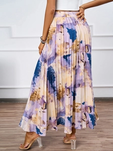 Close-up of pleated A-line skirt with purple oil painting print and elastic waistband