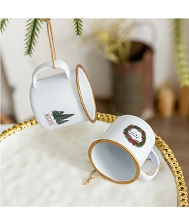 Detail of Christmas mini mugs with Believe and Joy prints and festive hanging ropes