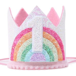 Close-up of glittery rainbow pet birthday crown with pink fur trim and number 1 detail