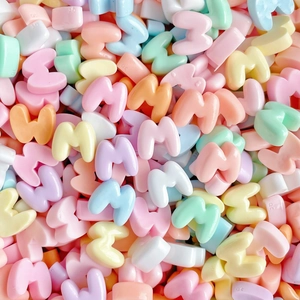 Mix of small M-shaped resin beads in pastel macaron colors for DIY jewelry and phone cases