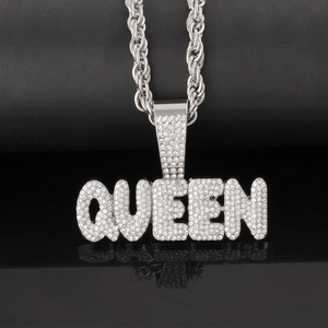 Macro shot of silver Queen letter pendant encrusted with diamonds on twisted rope chain