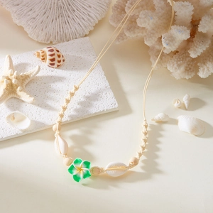 Handmade shell and flower woven necklace for beach vacation with bohemian style elements
