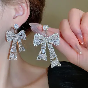 Elegant silver bow earrings with sparkling trapezoid zircon crystals for a luxury look