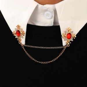 Vintage gold collar chain with red gemstones and crystals on white shirt collar
