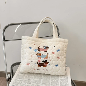 Close-up of cream quilted cotton tote bag with puppy embroidery and nice day text