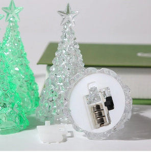 Detail shot of the LED Christmas tree base showing the battery compartment and cells