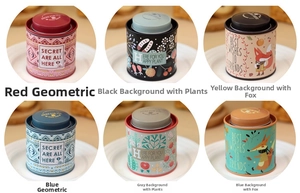 Detailed view of six decorative tin canisters with floral patterns and inner lids