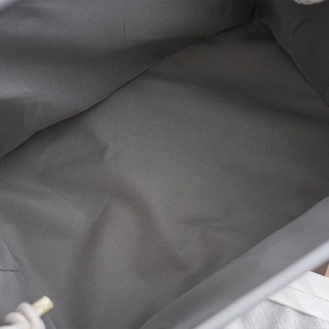 Close-up of the woven gray fabric texture and interior space of the large storage basket