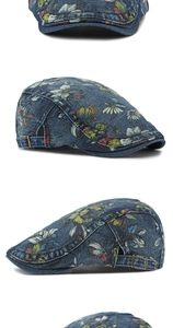 Detail of floral printed denim newsboy cap with vintage metal buckle and colorful pattern