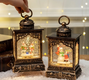 Close-up of vintage bronze Christmas lanterns with snowmen and LED glowing snow scenes