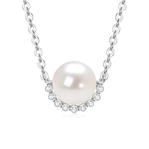 Macro shot of white round pearl pendant with pavé diamond setting on elegant silver chain
