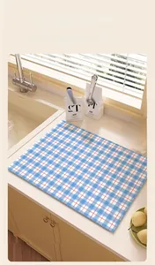Close-up of blue and white checkered absorbent mat for kitchen countertops and coffee bars
