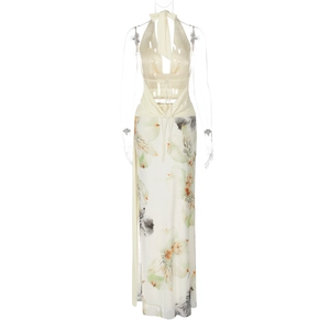 Detail of backless halter top and floral slit skirt on a white studio mannequin