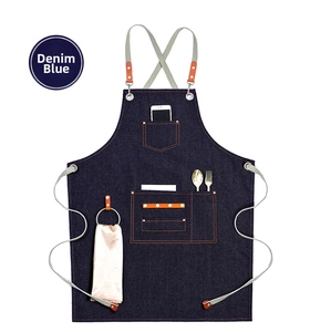 Detail of dark blue denim apron with multi-function pockets and orange leather accents