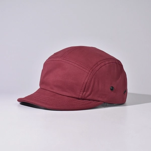 Detail of burgundy 5-panel camper hat showing fabric texture and metal side eyelets