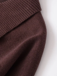 Detailed macro shot of coffee brown knit sweater texture and ribbed neckline finish