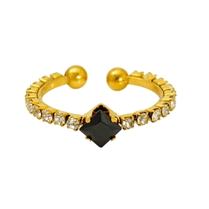 Macro shot of gold-plated open ring featuring a square black stone and crystal accents