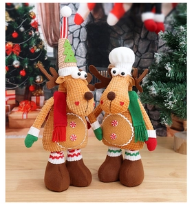 Detail view of plush Christmas reindeer dolls in gingerbread brown corduroy with scarves