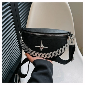 Detail of black pebbled leather waist bag with silver star logo and Cuban chain strap