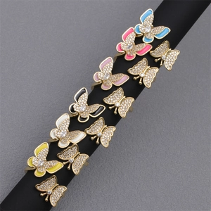 Macro view of colorful enamel butterfly rings with micro-set zircons on black display stand