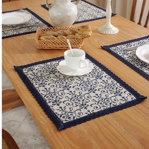 European vintage linen placemats with blue floral prints and navy lace edges