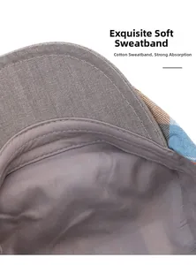 Detail of grey cotton sweatband with double stitching inside plaid beret hat