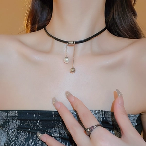 Detail of vintage choker necklace with white pearl and squirrel motif ring set