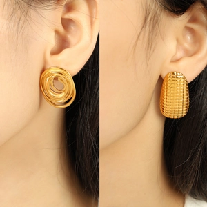 Fashionable golden spiral and textured oval hoop earrings for women on model