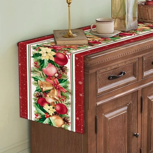 Detail of Christmas table runner with golden bells and pine needle festive patterns
