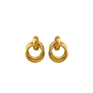 Close-up of polished gold triple-intertwined hoop earrings with a dome stud top