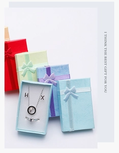 Detailed view of colorful jewelry gift sets featuring elegant necklaces and rings in boxes