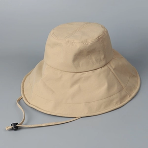 Detail of khaki wide-brim bucket hat with reinforced stitching and adjustable wind cord