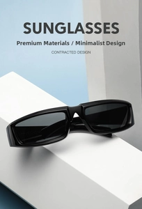 Detail of black rectangular Y2K sunglasses on white geometric display with soft lighting