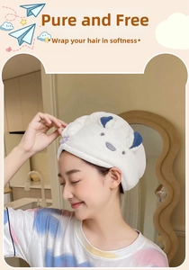 Close-up of a white microfiber hair towel featuring cute bear ears and blue accents