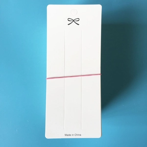 White cardboard jewelry display cards with hanging hole and black bow design details