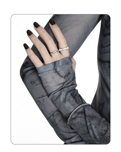Detail shot of vintage silver S925 rings and bracelets paired with grey textured fabric