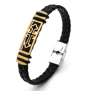 Detail of black braided leather men's bracelet with golden cross charm and clasp
