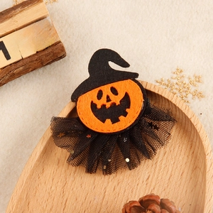 Detail of Halloween hair clip with felt pumpkin, wizard hat, and black polka dot mesh veil